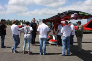 Flight instructor and fly-off pilot Josh Lafferty gives the crew a safety briefing before giving each an introductory flight in a Glasair Sportsman. Passengers took the left seat.